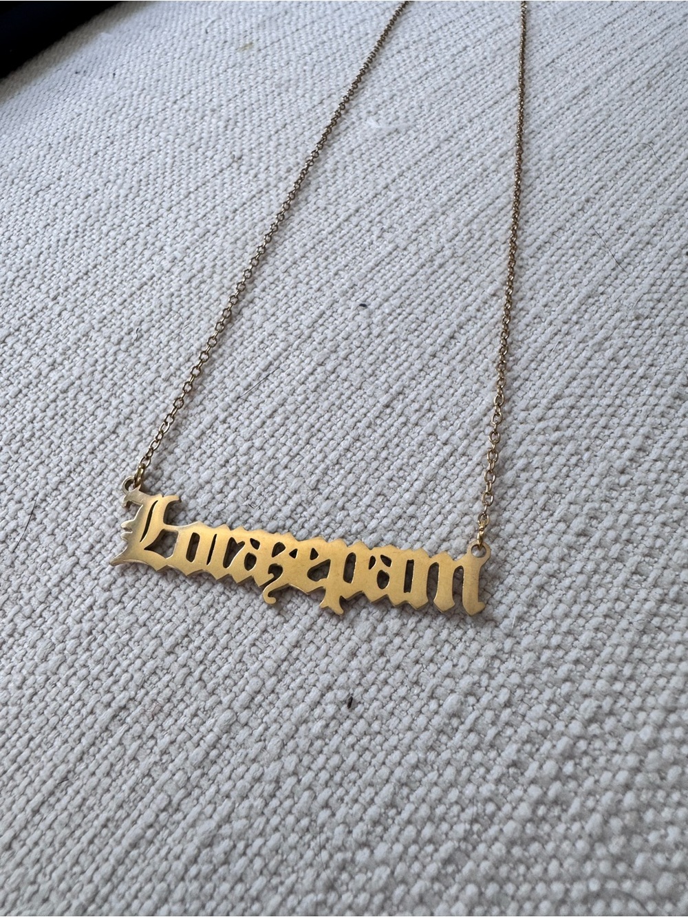White lotus gold plated gothic font necklace RX